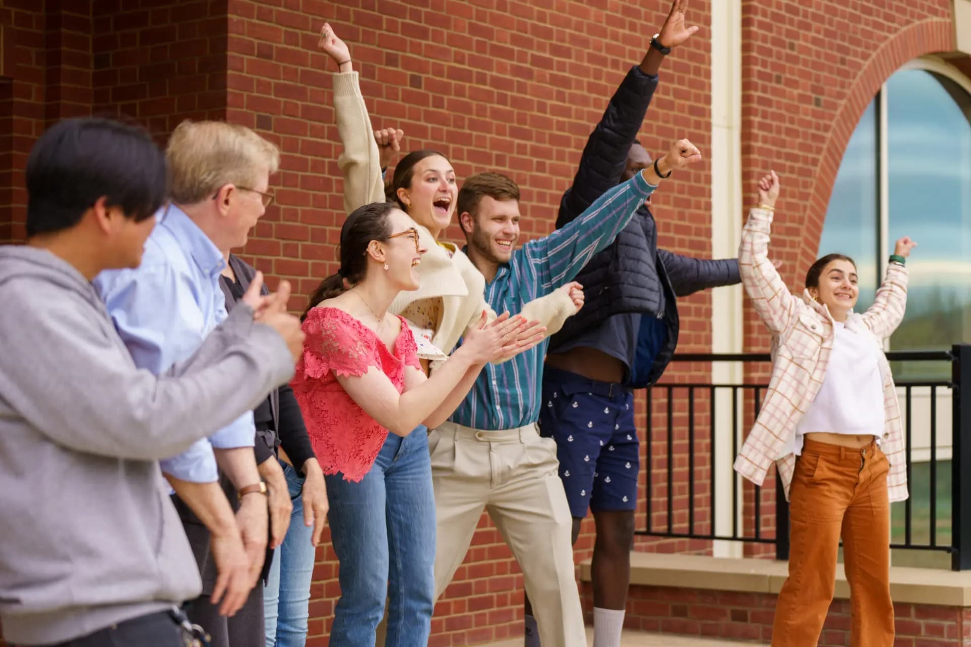 Happy people sheering with their hands in the sky