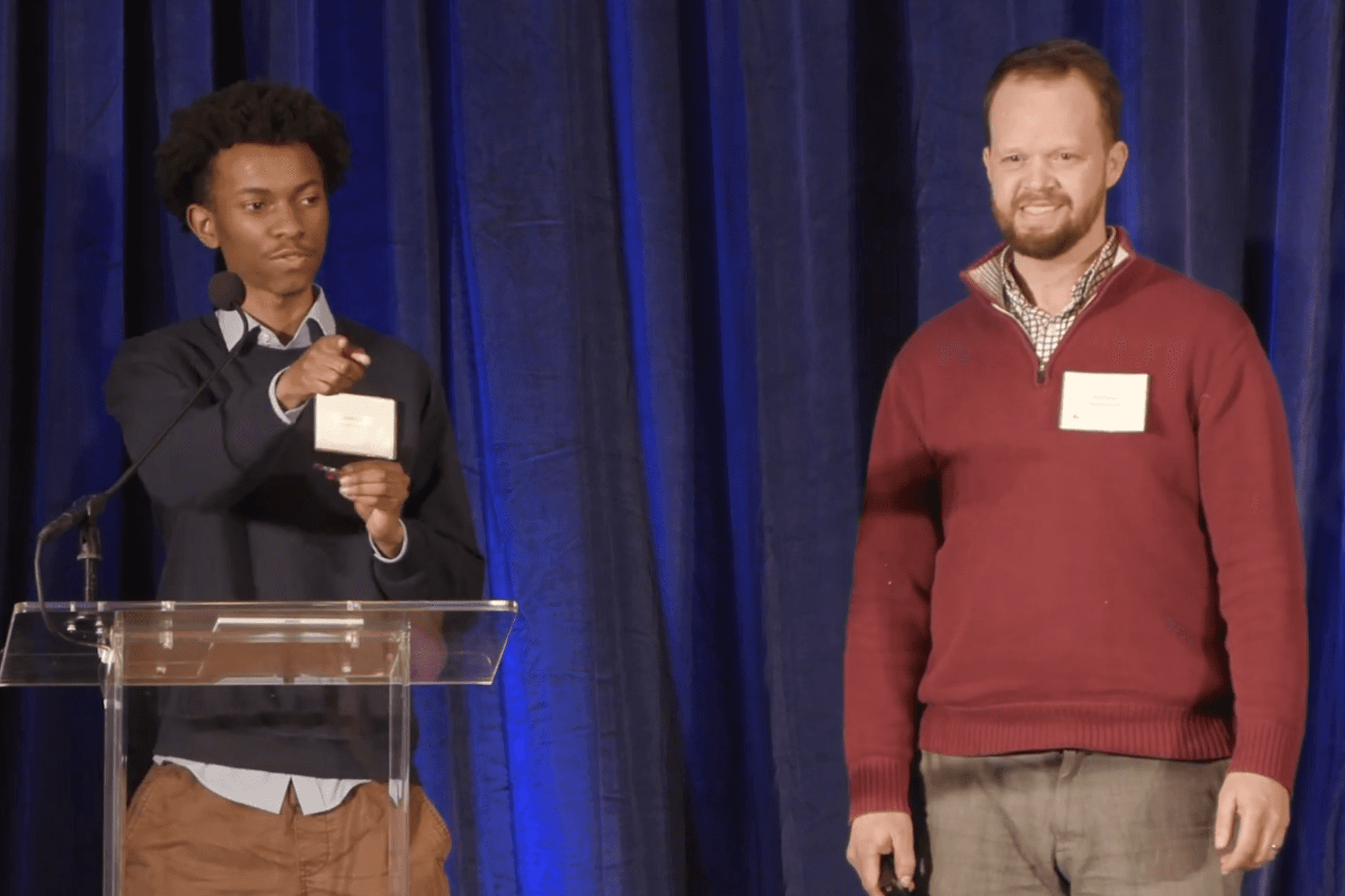 Two men talking on stage