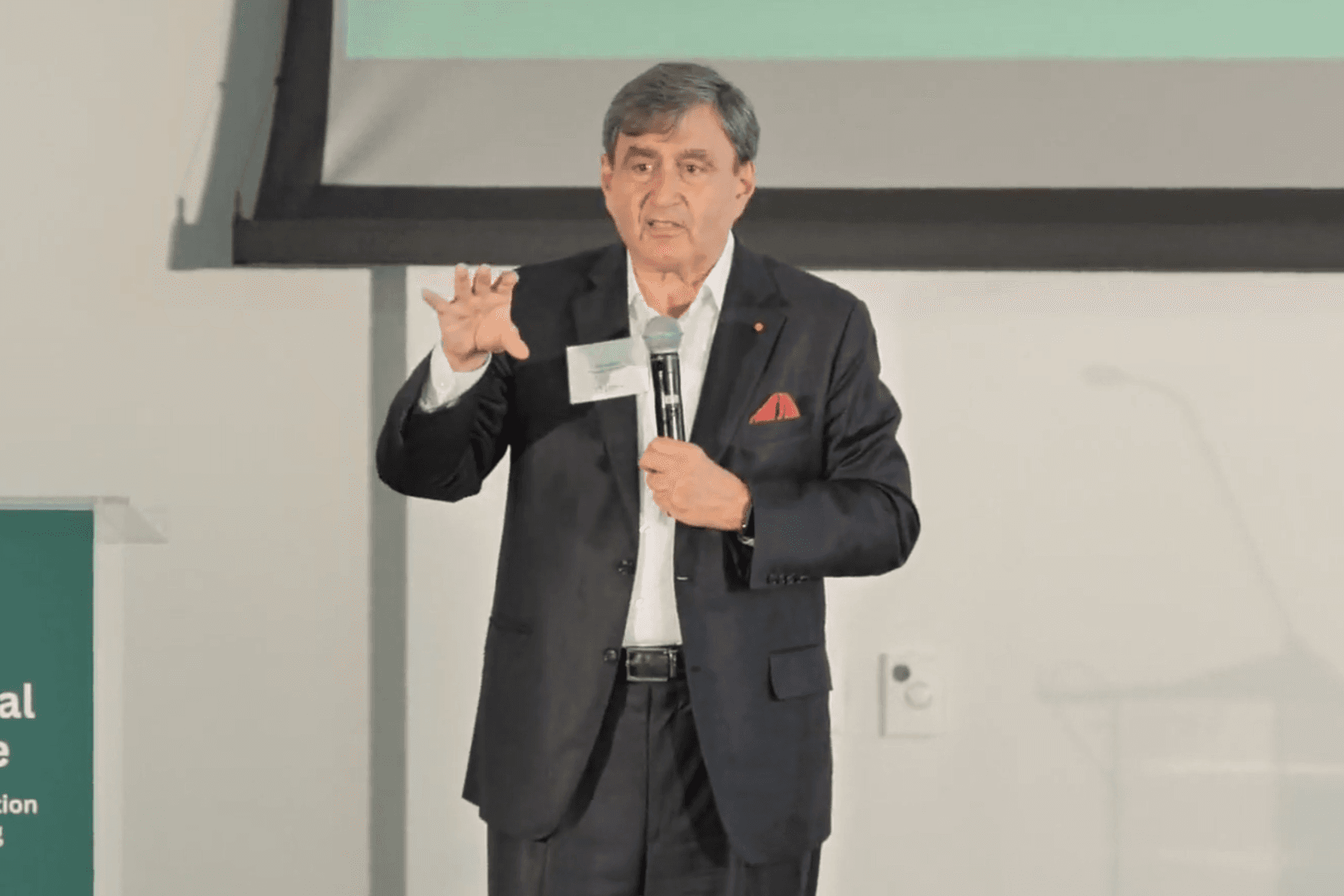 Man in suit talking on stage